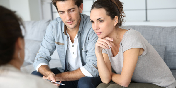 couple listening to a surveyor